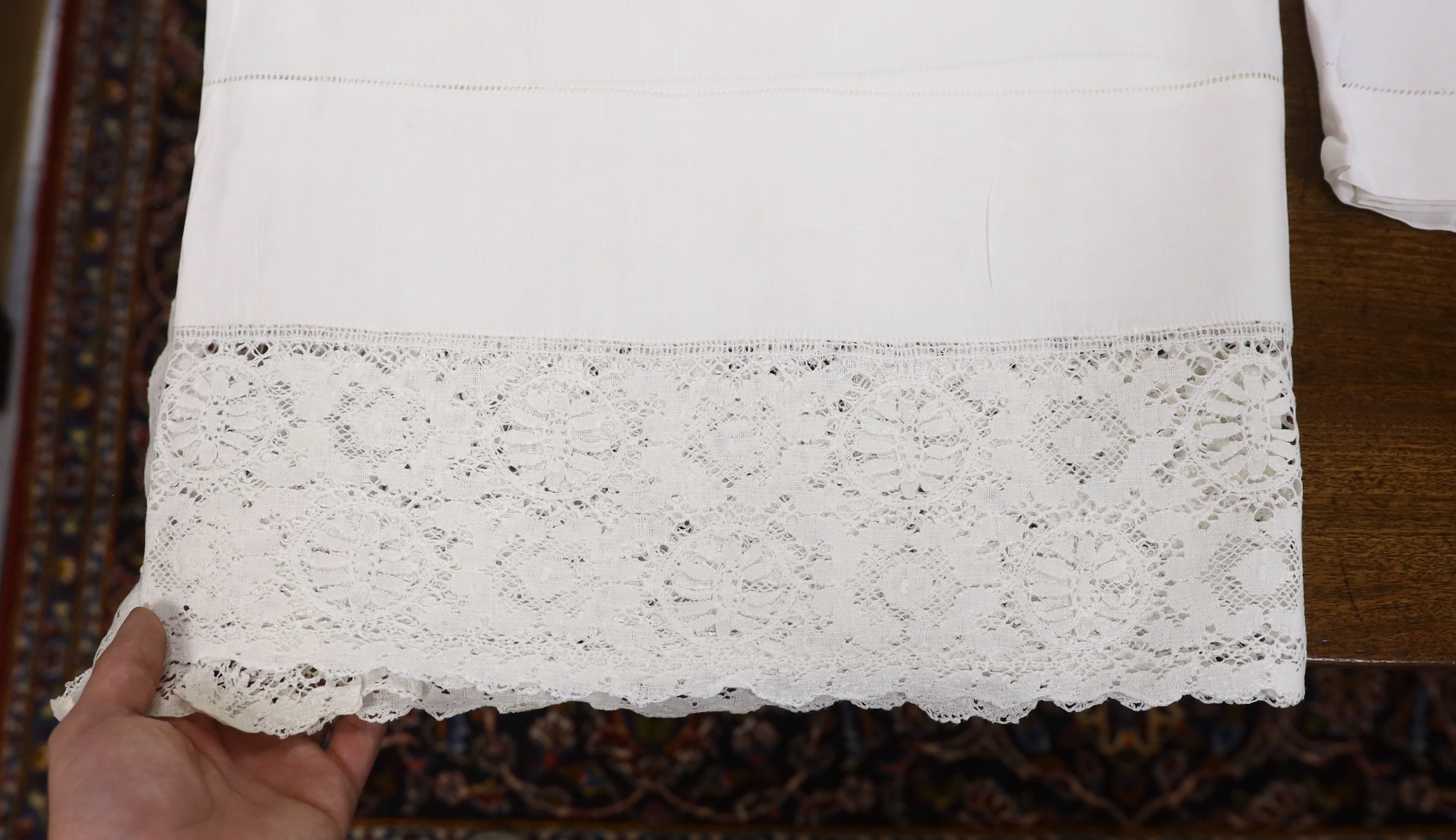 Table linen; A large linen embroidered and finely worked table cloth, an Anglaise worked cloth with crochet border and a fine appliqué cloth (3)